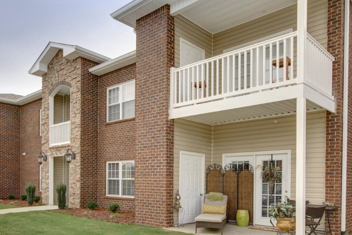 Seville Place furnished patio home with arched entry and upstairs balcony