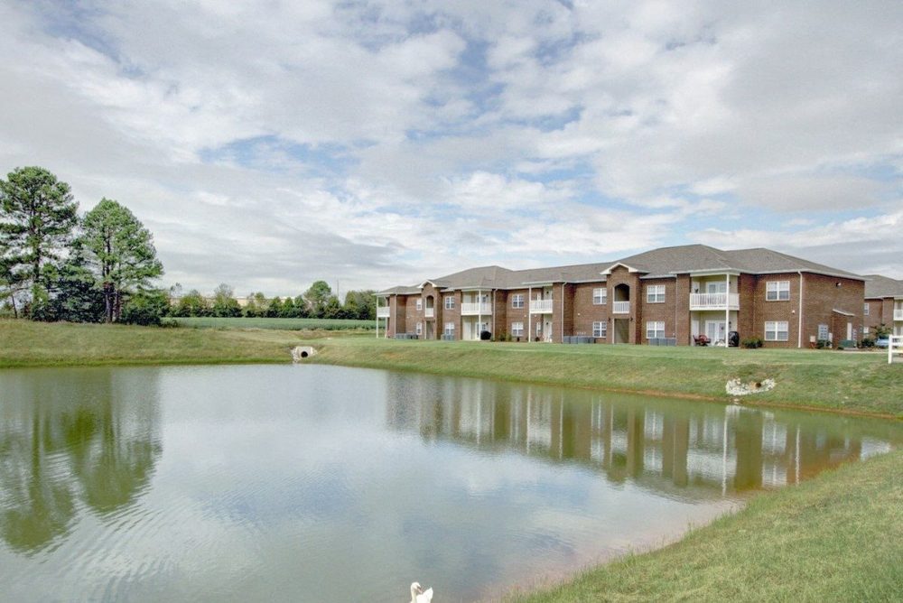 The one-and-a-half acre pond at Seville Place reflecting the apartment buildings